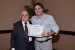 Dr. Nagib Callaos, General Chair, giving Prof. Marcelo Franco Porto the best paper award certificate of the session "Risk, Management, Engineering and Informatics." The title of the awarded paper is "Automatic Analysis of Standards in Rail Projects."
